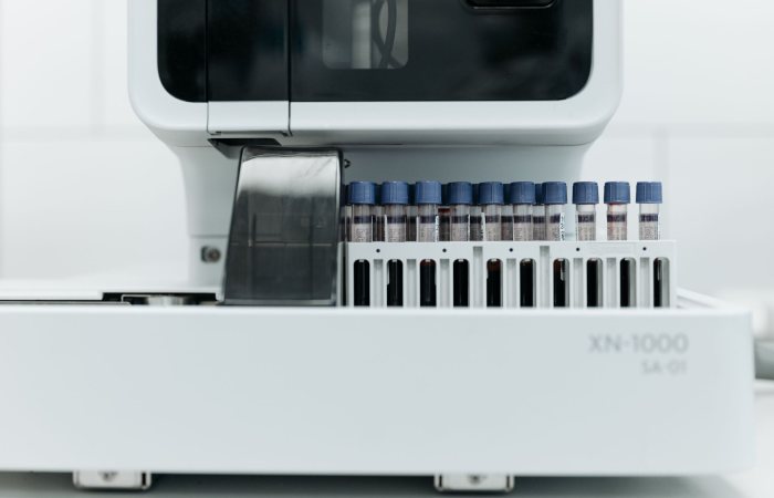 Close-up of laboratory machine holding test tubes for analysis.